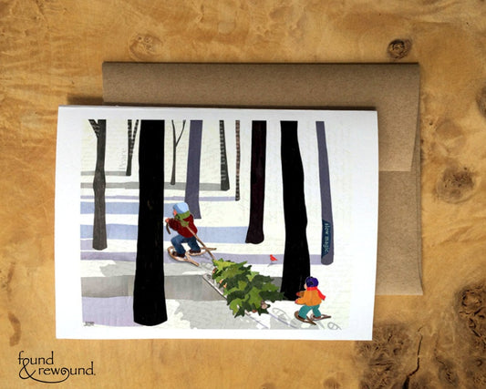 Holiday Greeting Card of a Father and Child Gathering a Christmas Tree in the Snow Woods Seasons Greetings