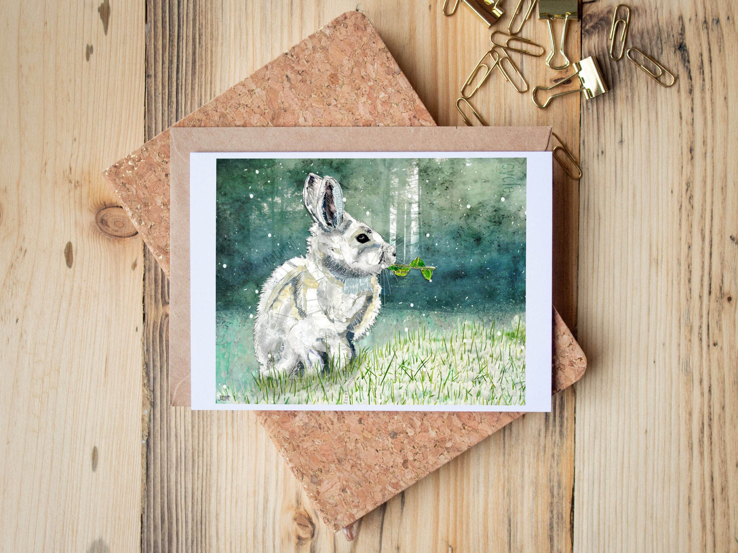 Greeting Card of mixed media collage of a snowshoe hare in the first snow of the season, forest background - Blank Inside