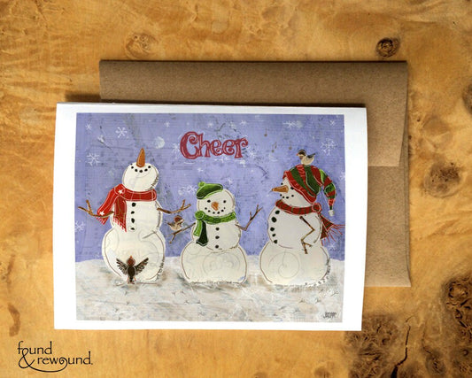Holiday Greeting Card of Three Snowmen With Three Birds and the Words "Cheer" - Blank Inside