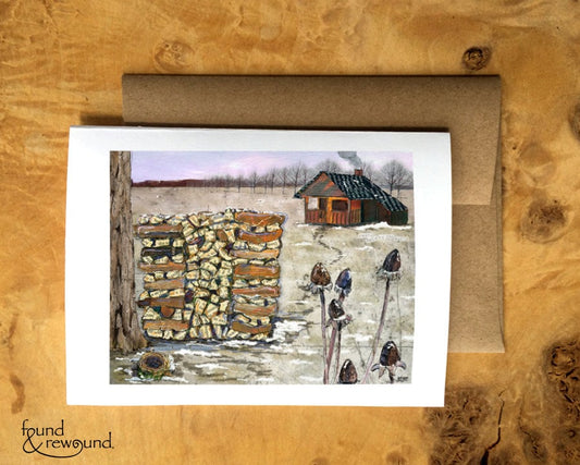 Greeting Card of a Paper Collage of a stack of firewood in front of a home with smoke from the chimney - Blank Inside