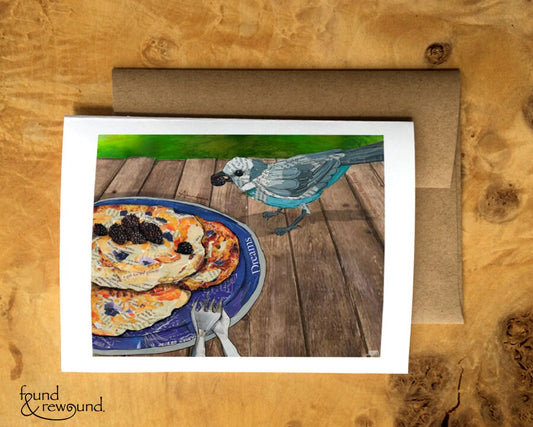 Greeting Card of a mixed media collage of a grey jay stealing a blackberry from a camper's pancakes - blank inside